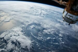 Project Suncatcher satellite research with a view of Earth from orbit