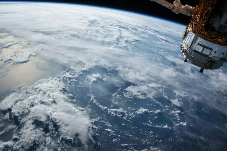 Project Suncatcher satellite research with a view of Earth from orbit